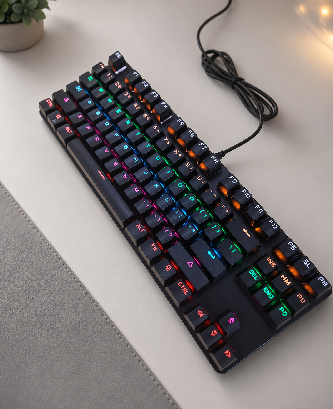 Black 87-key wired RGB mechanical keyboard on a clean desk setup