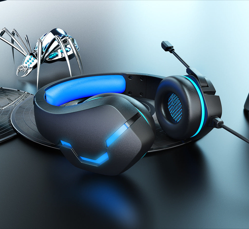 Black-blue wired gaming headset in a blue desk setup