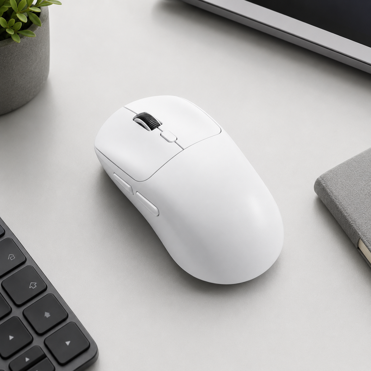 White tri-mode wireless mouse on a clean workspace